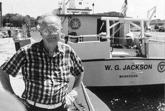 Dr. Bill Jackson poses for a photo by the research vessel W.G. Jackson, named in his honor.